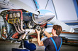 Replacing the defective parts of the aircraft service worker.