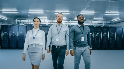 Aufkleber - Professional Team of Data Center IT Specialists Walking Away From the Working Server Cabinets Rack Corridor with a Laptop Computer. They Are Dressed Smart.