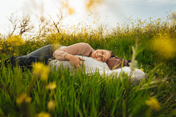 Wall Mural - romantic couple lying in the flowering meadow
