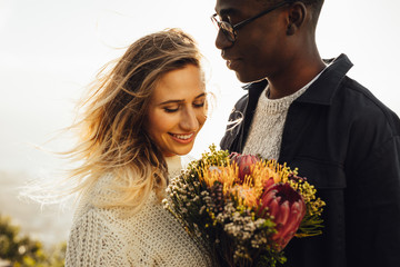 Wall Mural - Beautiful couple outdoors with flowers