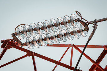 Power pylon array and details. Energy plant, red and white metal. Elctricity distribution grid, clean energy and local politics. National consumer supply for housing and cities. 