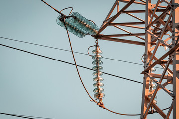 Power pylon array and details. Energy plant, red and white metal. Elctricity distribution grid, clean energy and local politics. National consumer supply for housing and cities. 