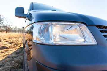 close-up of black car glowing front headlight