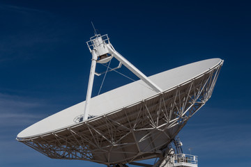 Wall Mural - very large array close view of a radio antenna dish against a deep blue sky, space technology, horiz
