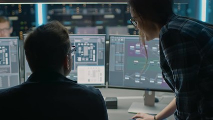 Fototapete - Male and Female IT Engineers / Programmer Talking, Coding on Desktop Computers. Displays Show Software Development / Code Writing / Website Design / Database Architecture
