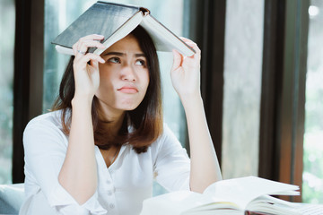 Asia woman reading book with boring.