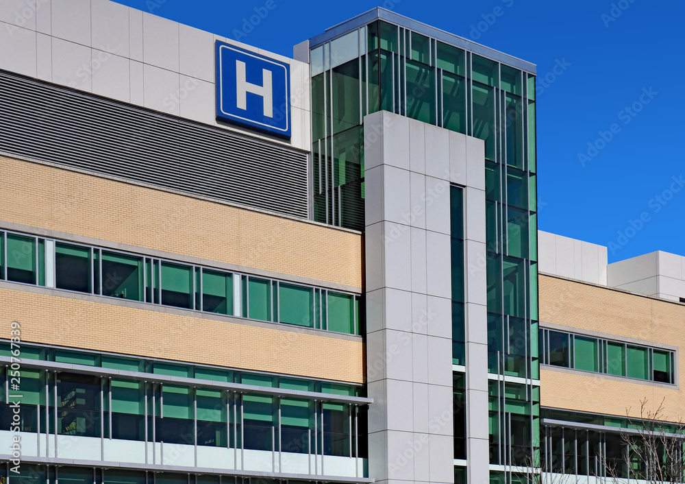 Modern style building with large H sign for hospital - obrazy, fototapety, plakaty 