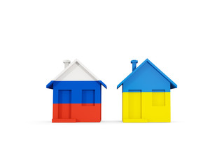 Two houses with flags of Russia and ukraine