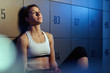 © Drazen - Female fighter concentrating for sports training in a locker room.