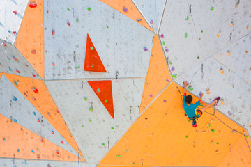 Sticker - The climber trains on an artificial relief.