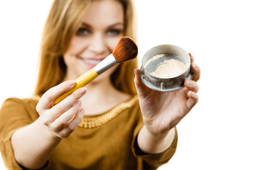 Smiling woman holding make up brush