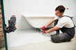 © Kadmy - bathtube installation. plumber installing and mounting bath with laser level