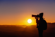 Young Woman Photographer Taking Photo With Sunset On Mountain Natural Background.