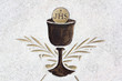 Eucharist - christian sacral ritual with cup, sacramental wine and bread. Icon and pictogram. JHS - Jesus Savior of Mankind