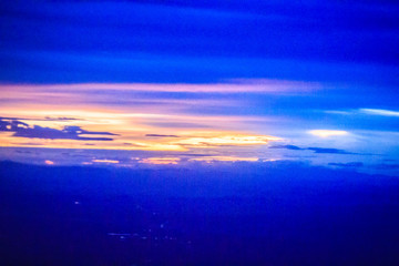 Wall Mural - Dusk sky and cloud at morning dawn background. Vibrant colors of the sky with clouds from dusk till dawn. Dramatic evening cloudscape in the city. Twilight sky began to change from blue to orange.