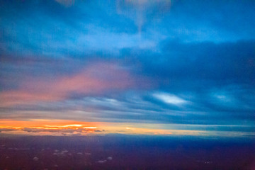 Wall Mural - Dusk sky and cloud at morning dawn background. Vibrant colors of the sky with clouds from dusk till dawn. Dramatic evening cloudscape in the city. Twilight sky began to change from blue to orange.