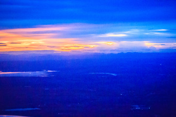 Wall Mural - Dusk sky and cloud at morning dawn background. Vibrant colors of the sky with clouds from dusk till dawn. Dramatic evening cloudscape in the city. Twilight sky began to change from blue to orange.