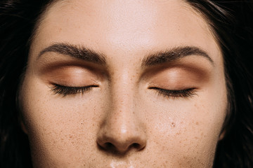 Wall Mural - close up view of girl with closed eyes and freckles on face