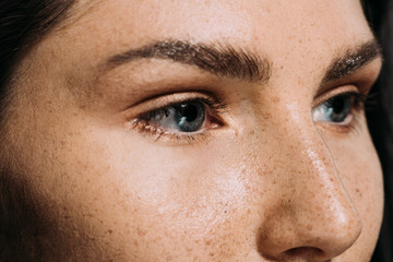 Wall Mural - close up view of beautiful girl with freckles on face