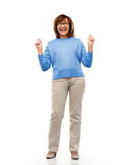 Wall Mural - success and old people concept - portrait of happy laughing senior woman in glasses celebrating triumph over white background