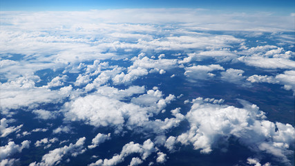 Wall Mural - flying over picturesque white clouds on the deep blue sky. beautiful moving clouds view from airplan