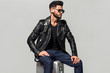 © ASjack - Elegant young handsome man with luggage. Studio fashion portrait.