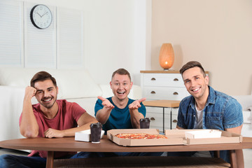 Poster - Group of friends with tasty food laughing while watching TV at home