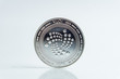 IOTA. Crypto currency silver coin, Macro shot of Iota coin isolated on white background, cut out Blockchain technology,