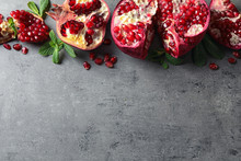 Flat Lay Composition With Ripe Pomegranates And Space For Text On Grey Background