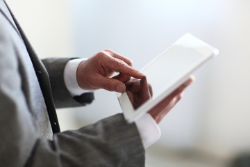 Wall Mural - close up.the businessman's hand presses on the screen of a digital tablet.photo with copy space