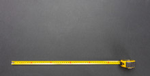 Yellow Measure Tape Isolated On Black Color Background, Top View, Copy Space