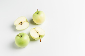 Wall Mural - green apples on wooden stand on white background