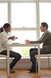 © Cavan Images - Couple talking at table