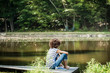 © Cavan Images - Teenage girl (14-15) relaxing on floating platform