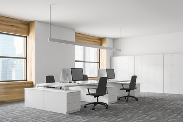 Corner of white and wooden office with lockers