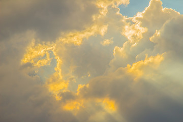 Wall Mural - Sunbeam shining through the cloud in the valley. Evening sunset with sun rays through the clouds.