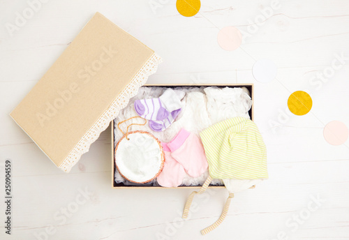 Fotomural Vintage keepsake box for preserving baby`s first clothes and things concept