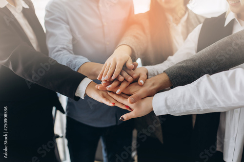Close up top view of young business people putting their hands together Tableau sur Toile