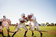 © Cavan Images - Teenage football team (14-15, 16-17) practicing tackle football