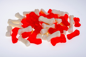 Wall Mural - Bone shaped jelly candies on white