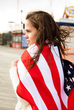 Young Woman Wrapped In American Flag 