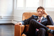 © Cavan Images - Portrait of businessman sitting in armchair