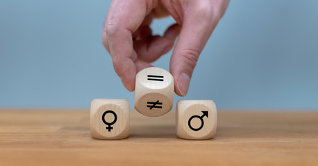 Symbol for gender equality. Hand turns a dice and changes a unequal sign to a equal sign between symbols of men and women.