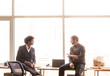© Cavan Images - Office workers discussing in office