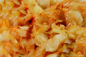 Wall Mural - Sauerkraut salad with  red Cayenne pepper texture as a background.