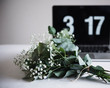 © Cavan Images - Bunch of flowers and clock on table