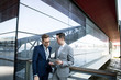 © Cavan Images - Two businessmen looking at digital tablet