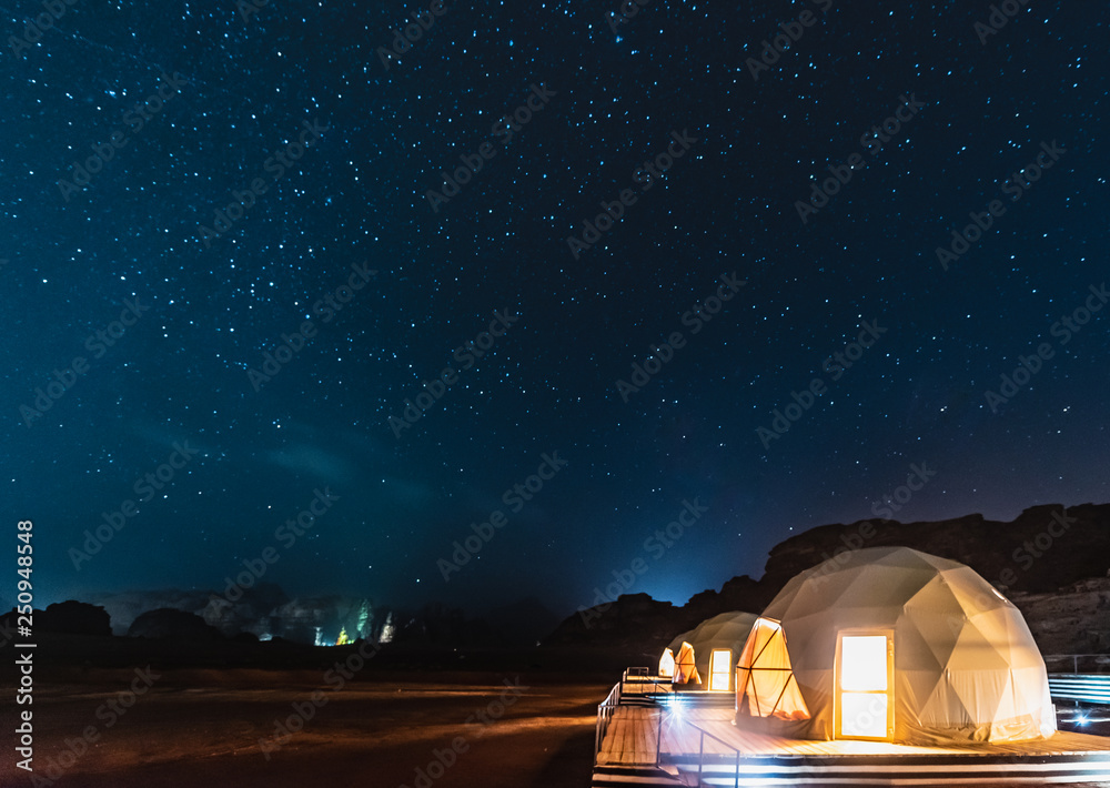 Stars above martian dome tents in Wadi Rum Desert, Jordan. - obrazy, fototapety, plakaty 