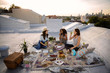 © Cavan Images - Friends having picnic on rooftop