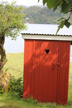Red Wooden Outhouse With Heart